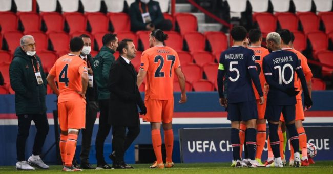 Istanbul Basaksehir's Turkish coach Okan Buruk (3rdL front) stands on the sideline as players argue during the UEFA Champions League group H football match between Paris Saint-Germain (PSG) and Istanbul Basaksehir FK at the Parc des Princes stadium in Paris, on December 8, 2020. (Photo by FRANCK FIFE / AFP) (Photo by FRANCK FIFE/AFP via Getty Images)